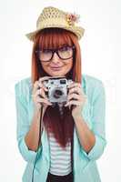 Portrait of a smiling hipster woman holding retro camera