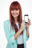 Smiling hipster woman showing her smartphone