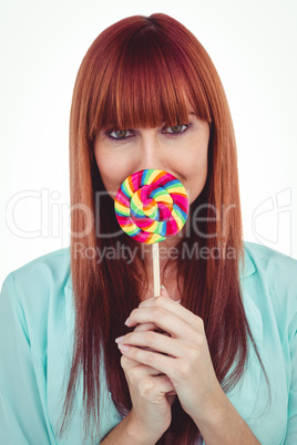 Smiling hipster woman with a lollipop