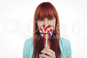 Smiling hipster woman with a lollipop