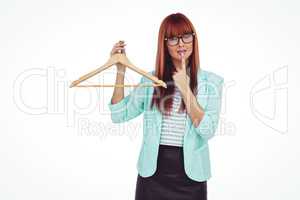 Hipster woman holding clothes hanger