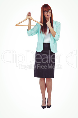 Hipster woman holding clothes hanger