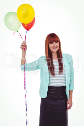 Smiling hipster woman holding balloons Smiling hipster woman holding balloons