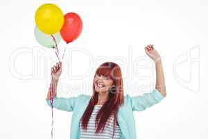 Smiling hipster woman holding balloons