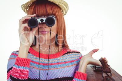 Smiling hipster woman looking through binoculars