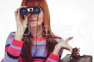 Smiling hipster woman looking through binoculars