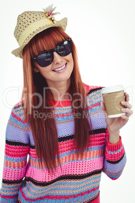 Attractive hipster woman holding a cup of coffee