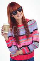 Attractive hipster woman holding a cup of coffee