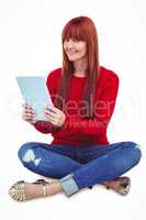 Smiling hipster woman sitting on the floor