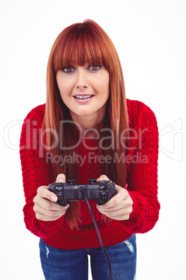 Smiling hipster woman playing video games