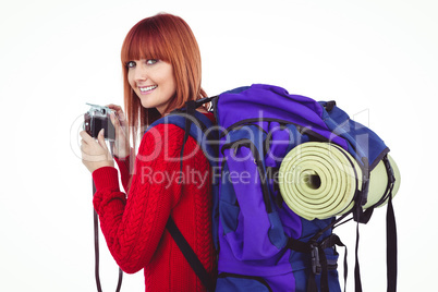 Smiling hipster woman with a travel bag