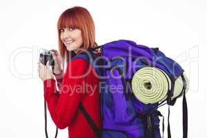 Smiling hipster woman with a travel bag