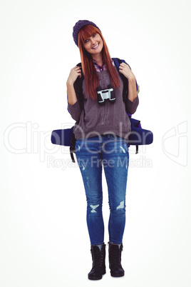 Smiling hipster woman with a travel bag