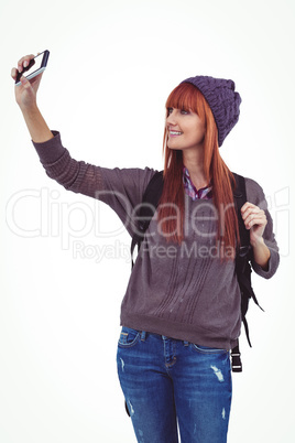 Smiling hipster woman taking selfie