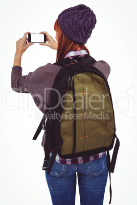 Smiling hipster woman taking selfie