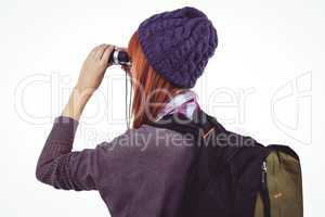 Hipster woman looking through binoculars