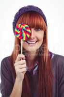 Smiling hipster woman with a lollipop