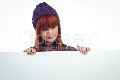 Smiling hipster woman holding big white card Smiling hipster woman holding big white card