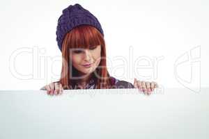 Smiling hipster woman holding big white card