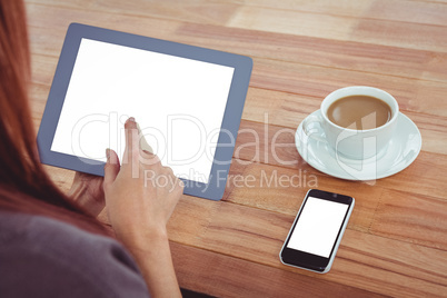 Over shoulder view of hipster woman using tablet