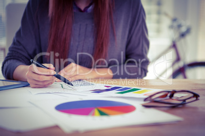 Mid section of a hipster woman working on graph