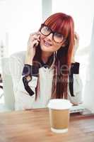 Smiling hipster businesswoman having a phone call