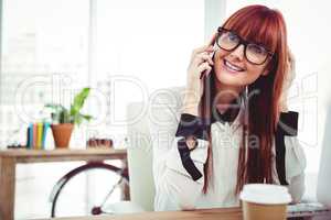 Smiling hipster businesswoman having a phone call