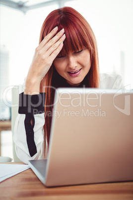 Hipster businesswoman having a headache