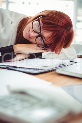 Hipster businesswoman falling in sleep at her desk