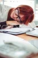 Hipster businesswoman falling in sleep at her desk