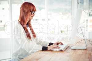 Hipster businesswoman using her computer