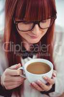 Hipster businesswoman holding a cup of coffee