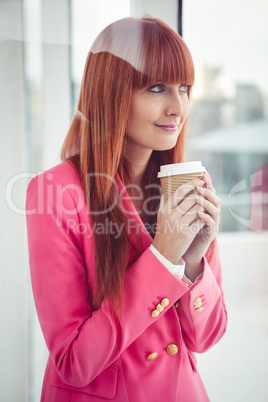 Portrait of a hipster businesswoman holding a coffee cup