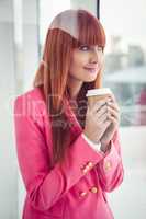 Portrait of a hipster businesswoman holding a coffee cup