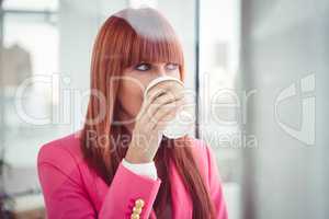 Portrait of a hipster businesswoman drinking a coffee cup