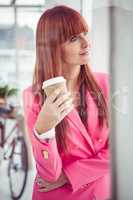 Portrait of a hipster businesswoman drinking a coffee cup