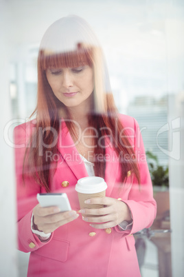 Hipster businesswoman texting with her smartphone