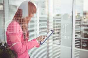 Hipster businesswoman using her tablet