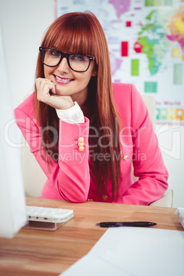 Smiling hipster businesswoman using her computer