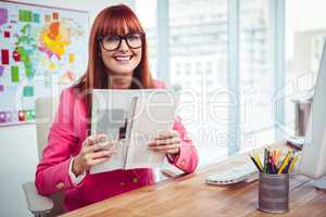 Smiling hipster woman with a book