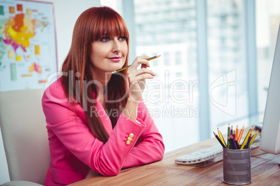 Hipster thoughtful businesswoman at her desk