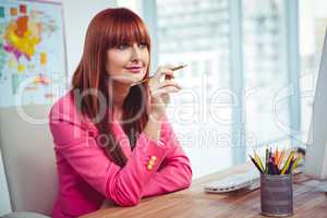 Hipster thoughtful businesswoman at her desk