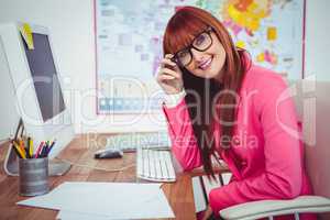 Smiling hipster businesswoman at her desk