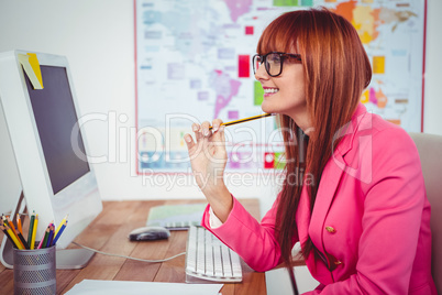 Smiling hipster businesswoman at her desk