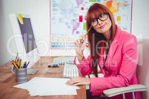 Smiling hipster businesswoman at her desk