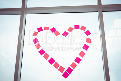 Heart in post-it on a window