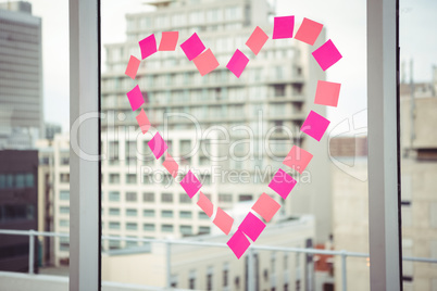 Heart in post-it on a window
