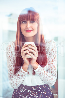 Smiling hipster businesswoman holding a coffee cup