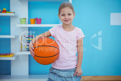 Cute girl holding basket ball