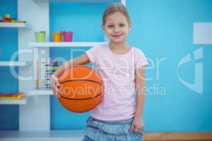 Cute girl holding basket ball